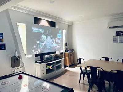 a living room with a large screen tv and a table at 9 Min KLCC 9KM Mid Valley Karaoke 30Pax 7Car in Kuala Lumpur