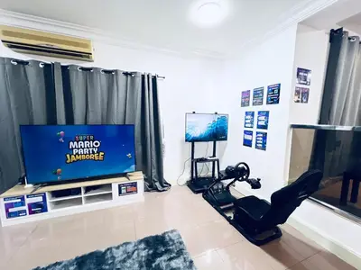 a living room with a flat screen tv sitting on a stand at 9 Min KLCC 9KM Mid Valley Karaoke 30Pax 7Car in Kuala Lumpur