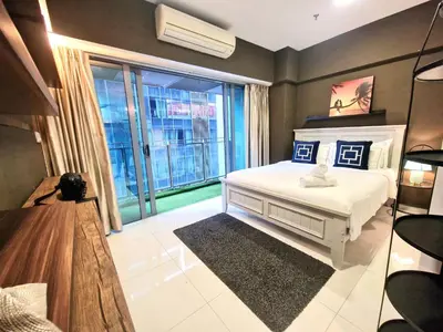 a bedroom with a white bed and a large window at Summer suites klcc by Amna in Kuala Lumpur