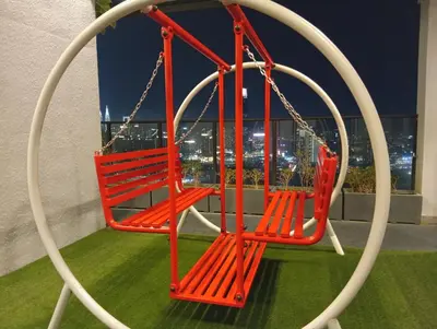 a swing on a balcony with a view of the city at B&B at TRION KL in Kuala Lumpur