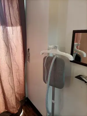 a bathroom with a towel rack and a mirror at Cozy Suite City Central in Kuala Lumpur