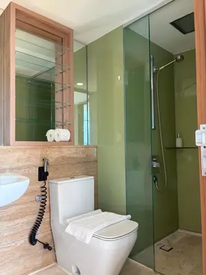 a bathroom with a toilet and a glass shower at sky suites by towerview in Kuala Lumpur