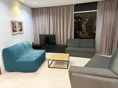 a living room with a couch and a chair and a table at sky suites klcc by afexten in Kuala Lumpur