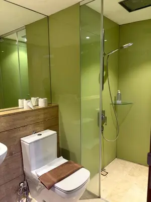 a bathroom with a toilet and a glass shower at sky suites klcc by afexten in Kuala Lumpur