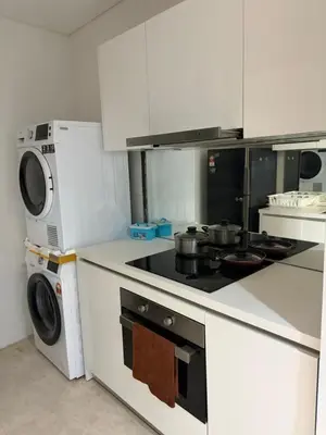 a kitchen with a stove and a microwave at sky suites klcc by afexten in Kuala Lumpur
