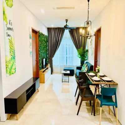 a dining room and living room with a table and chairs at sky suites klcc by Sweet home Apartment in Kuala Lumpur