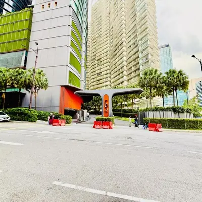 an empty street with red tables in front of buildings at sky suites klcc by Sweet home Apartment in Kuala Lumpur