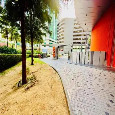 a sidewalk with a palm tree and a building at sky suites klcc by Sweet home Apartment in Kuala Lumpur
