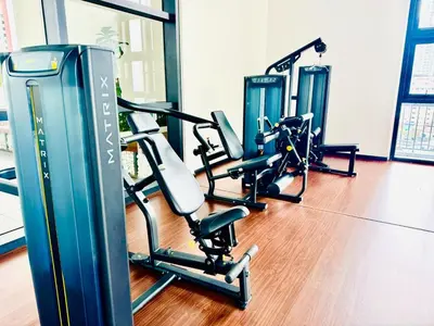 a gym with several treadmills and elliptical machines at KLCC SERVICED Suites CHAMBERS in Kuala Lumpur
