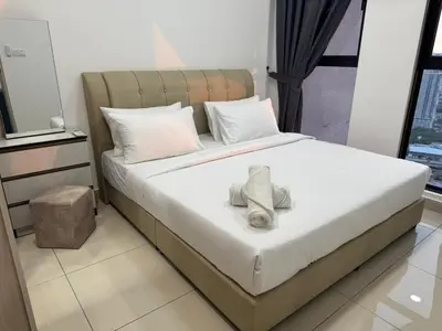 a bedroom with a bed with a towel on it at Trion sky suite KL in Kuala Lumpur