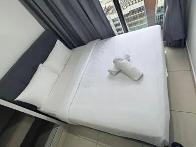a white bed in a room with a window at Trion sky suite KL in Kuala Lumpur