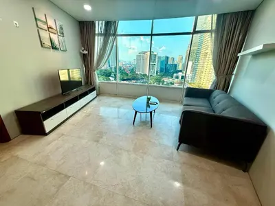 a living room with a couch and a large window at Vortex Suites Apartment Klcc in Kuala Lumpur