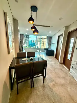 a living room with a table and chairs at Vortex Suites Apartment Klcc in Kuala Lumpur