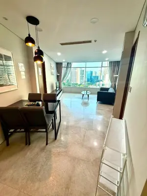 a living room with a couch and a table and chairs at Vortex Suites Apartment Klcc in Kuala Lumpur