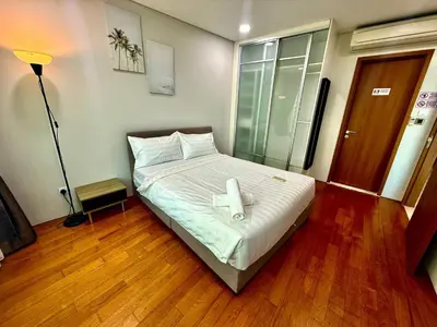 a bedroom with a bed with a cross on it at Vortex Suites Apartment Klcc in Kuala Lumpur