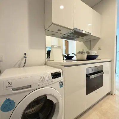 a white kitchen with a washing machine in it at 30 OFF Monthly l Premium 3BR Suite in KLCC in Kuala Lumpur