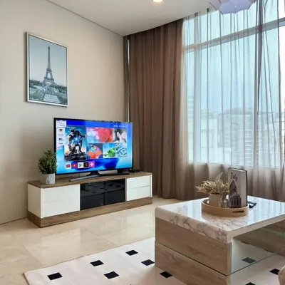 a living room with a flat screen tv and a table at 30 OFF Monthly l Premium 3BR Suite in KLCC in Kuala Lumpur