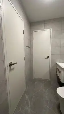 a bathroom with a white door and a toilet at KayooKiddieHouse KLCC Kids Friendly at Kg Baru KL in Kuala Lumpur