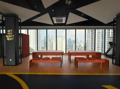 a room with two tables and benches and a large window at KayooKiddieHouse KLCC Kids Friendly at Kg Baru KL in Kuala Lumpur