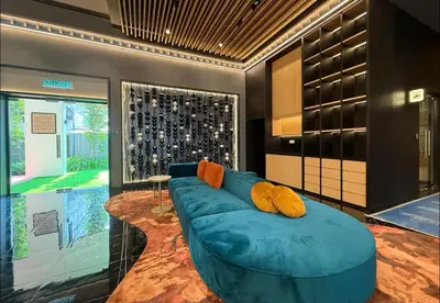 a living room with a blue couch in a room at KayooKiddieHouse KLCC Kids Friendly at Kg Baru KL in Kuala Lumpur