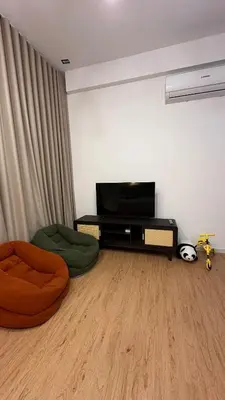 a living room with a flat screen tv and two chairs at KayooKiddieHouse KLCC Kids Friendly at Kg Baru KL in Kuala Lumpur
