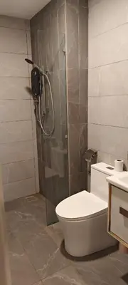 a bathroom with a toilet and a glass shower at Majestic Residence Klcc By DIVINA in Kuala Lumpur