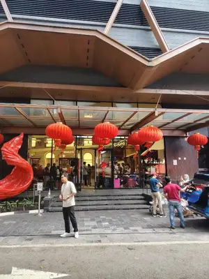 a group of people standing outside of a building with red lanterns at Scarletz Suites KLCC by cozy stay in Kuala Lumpur