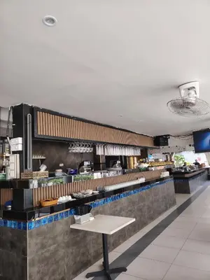 a restaurant kitchen with a table in the middle at Scarletz Suites KLCC by cozy stay in Kuala Lumpur