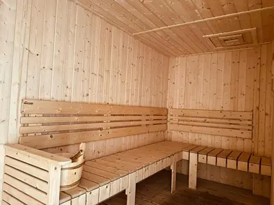 a wooden sauna with a bench and a dog in it at Majestic Suites klcc By Falak in Kuala Lumpur