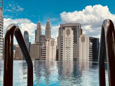a view of a city skyline from a swimming pool at Majestic Suites klcc By Falak in Kuala Lumpur