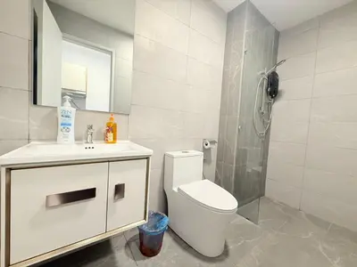 a bathroom with a toilet and a sink and a shower at Majestic Suites klcc By Falak in Kuala Lumpur