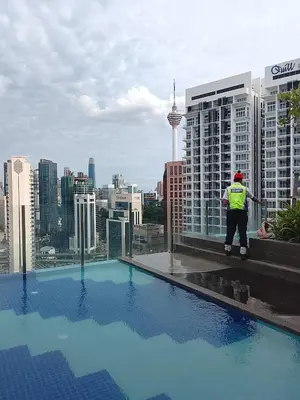 a man standing on the ledge of a building at Kuala Lumpur Majestic Suites KLCC in Kuala Lumpur