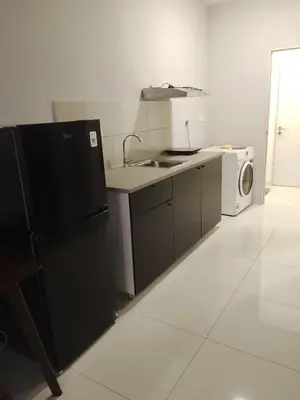 a kitchen with a black refrigerator and a microwave at Kuala Lumpur Majestic Suites KLCC in Kuala Lumpur