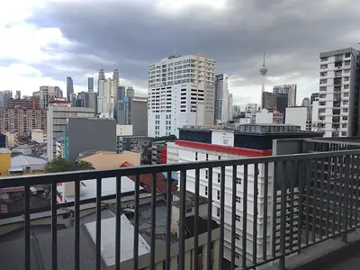a view of a city skyline from a balcony at Kuala Lumpur Chambers Suites KLCC in Kuala Lumpur