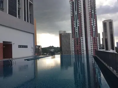 a swimming pool in a city with tall buildings at Kuala Lumpur Chambers Suites KLCC in Kuala Lumpur