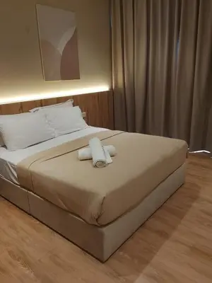 a bedroom with a bed with two towels on it at Quill Kuala Lumpur Suites KLCC in Kuala Lumpur
