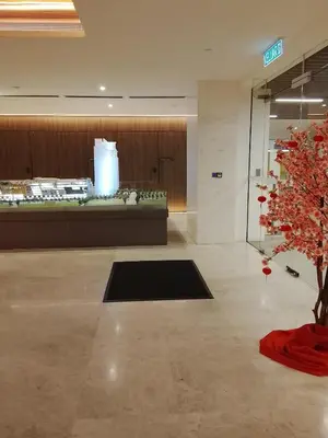 a lobby with a tree in the middle of a room at Quill Kuala Lumpur Suites KLCC in Kuala Lumpur