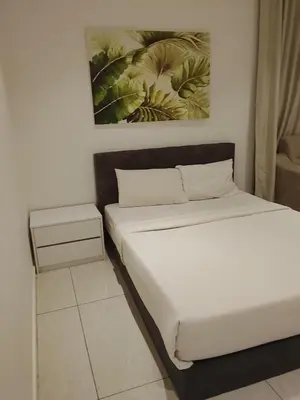 a bedroom with a bed and a painting on the wall at Quill Kuala Lumpur Suites KLCC in Kuala Lumpur
