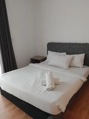 a white bed with two towels on top of it at Quill Kuala Lumpur Suites KLCC in Kuala Lumpur