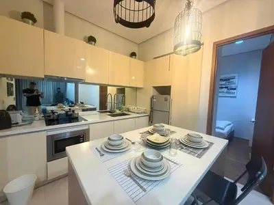 a kitchen with a table with plates on it at Soho Suites KLCC by MIMI in Kuala Lumpur