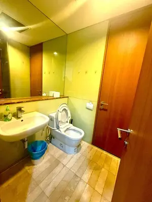 a bathroom with a white toilet and a sink at Soho Suites Klcc By Bukit Bintang in Kuala Lumpur