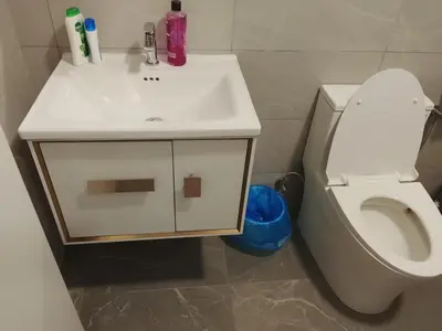 a bathroom with a white sink and a toilet at Majestic Suites Quill Mall Apartment in Kuala Lumpur