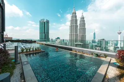 a swimming pool on the roof of a building with tall buildings at Star Residences One by The Conts in Kuala Lumpur