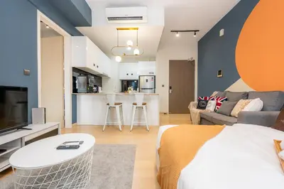 a bedroom with a bed and a living room at Star Residences One by The Conts in Kuala Lumpur
