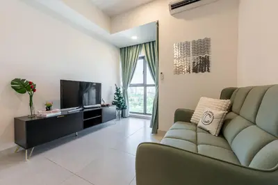 a living room with a couch and a television at The Atrium by The Conts in Kuala Lumpur