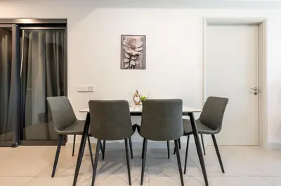 a dining room with a table and four chairs at The Atrium by The Conts in Kuala Lumpur