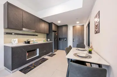 a kitchen with a table and a dining room at The Atrium by The Conts in Kuala Lumpur
