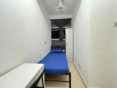 a small room with a blue bed in it at Male Room at Berjaya Times Square, KL City Centre in Kuala Lumpur