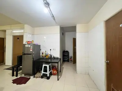 a kitchen with a refrigerator and a table in it at Male Room at Berjaya Times Square, KL City Centre in Kuala Lumpur