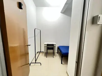 a hallway with a blue bench and a table at Male Room at Berjaya Times Square, KL City Centre in Kuala Lumpur